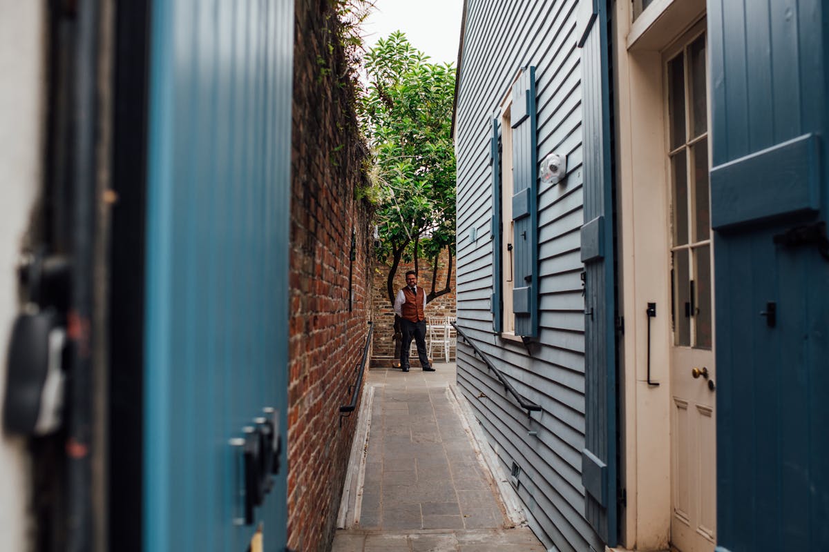 a narrow street in front of a brick building