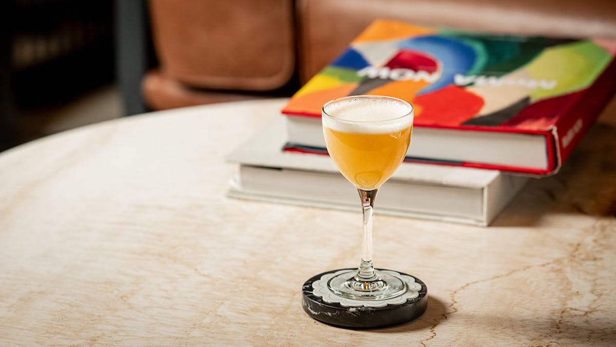 a glass of wine sitting on top of a table