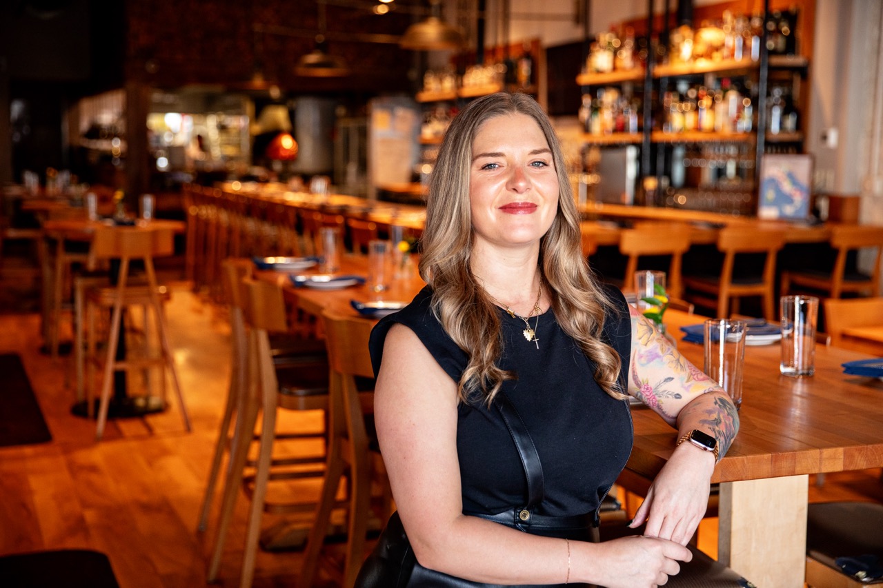 a woman sitting at a table in a restaurant