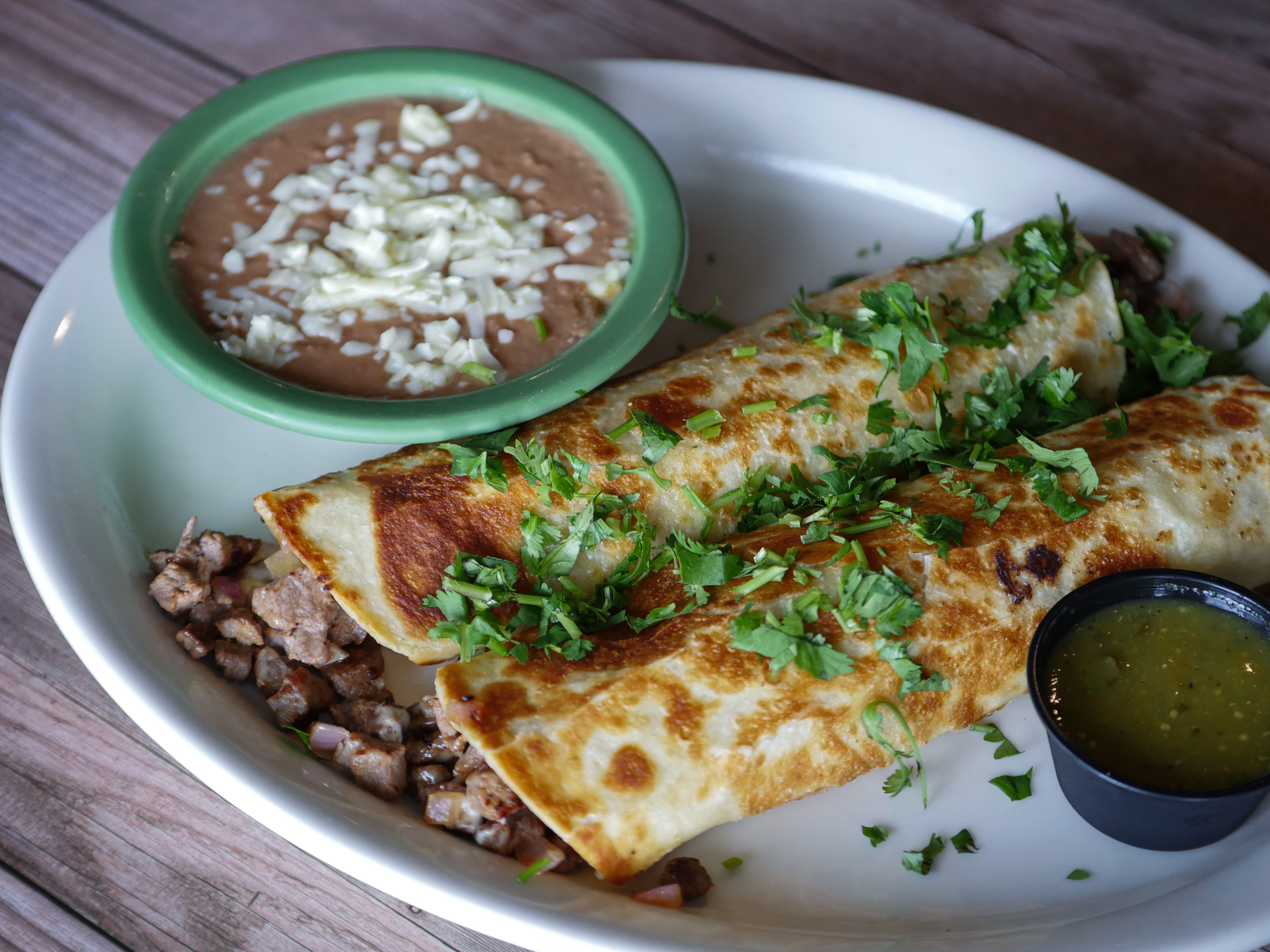 a plate of food with a slice of pizza