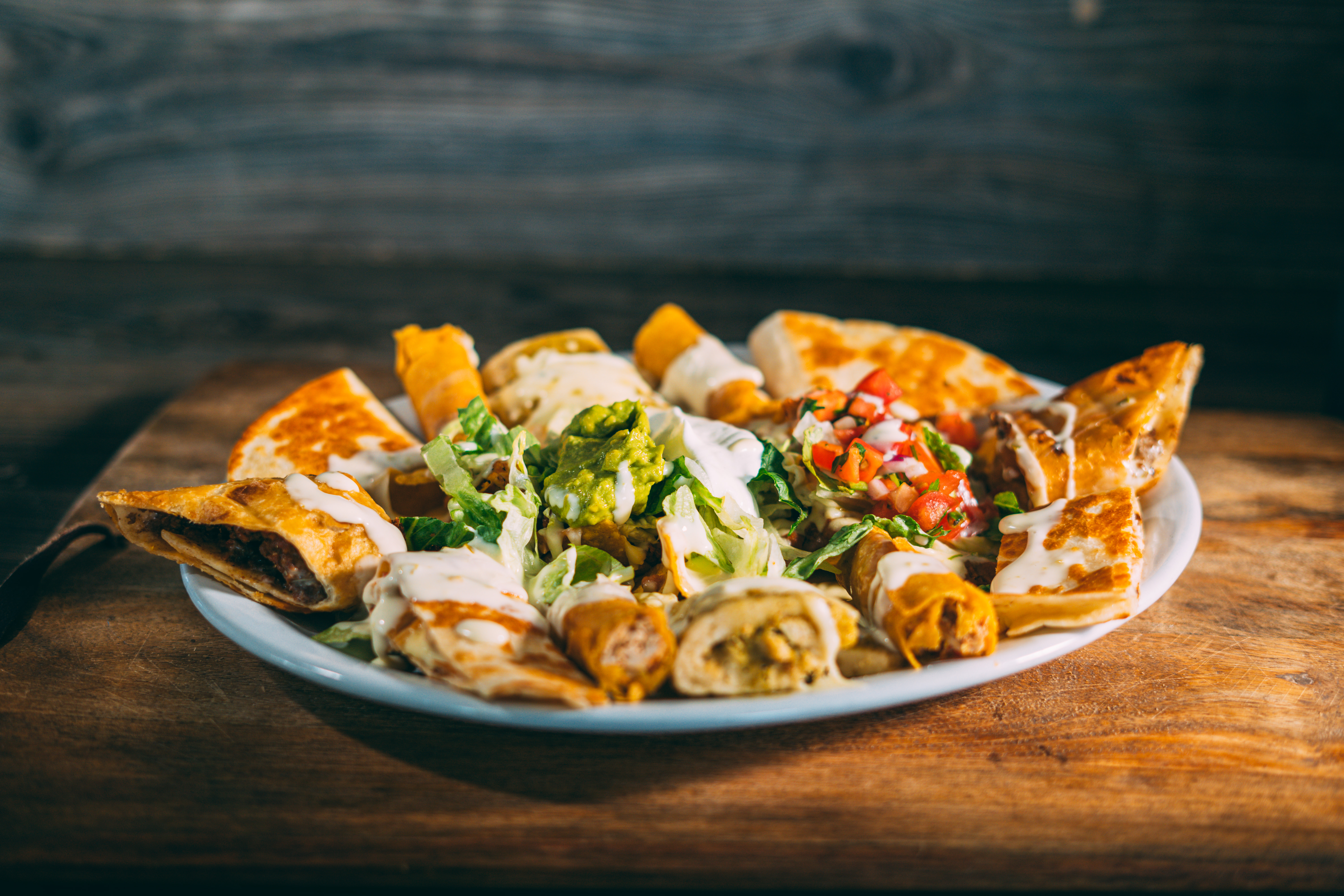a plate of food sitting on top of a wooden table