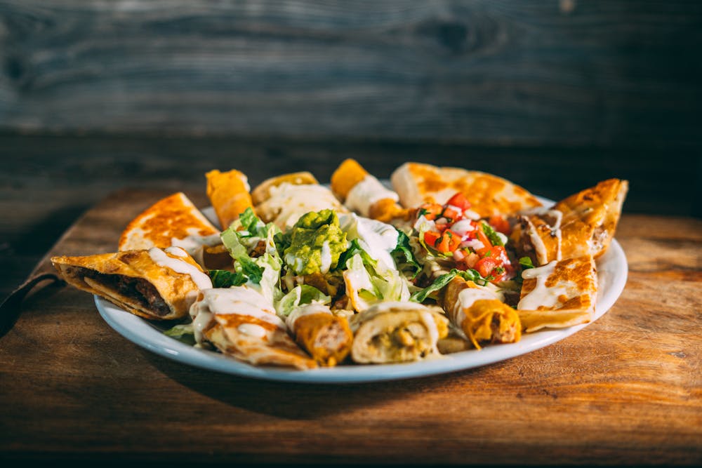 a plate of food sitting on top of a wooden table