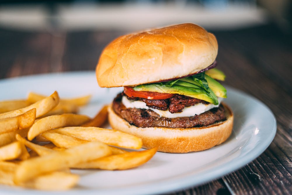 a close up of a sandwich and fries on a plate