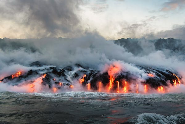 a fire pit with smoke coming out of the water