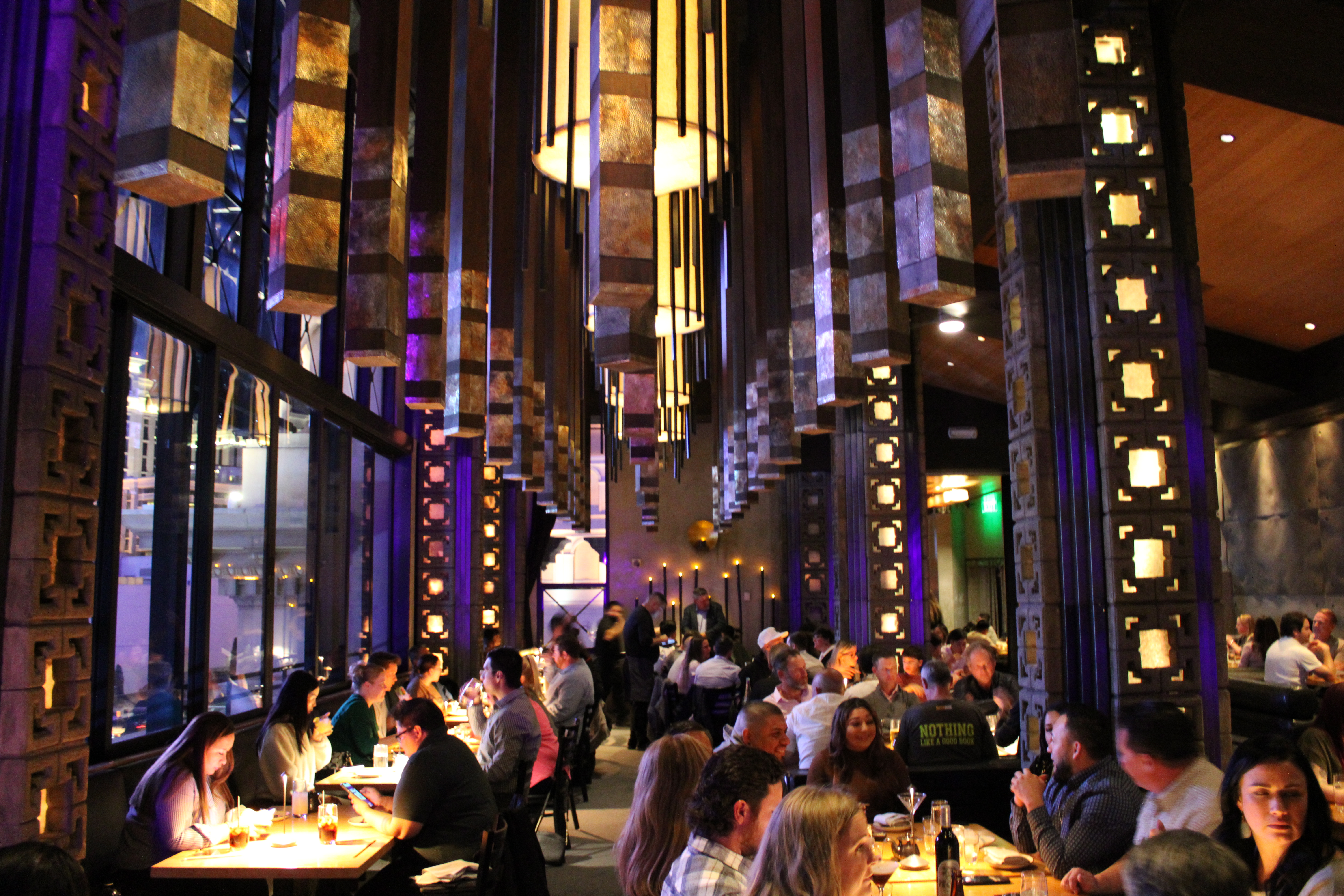 a group of people on a city street at night