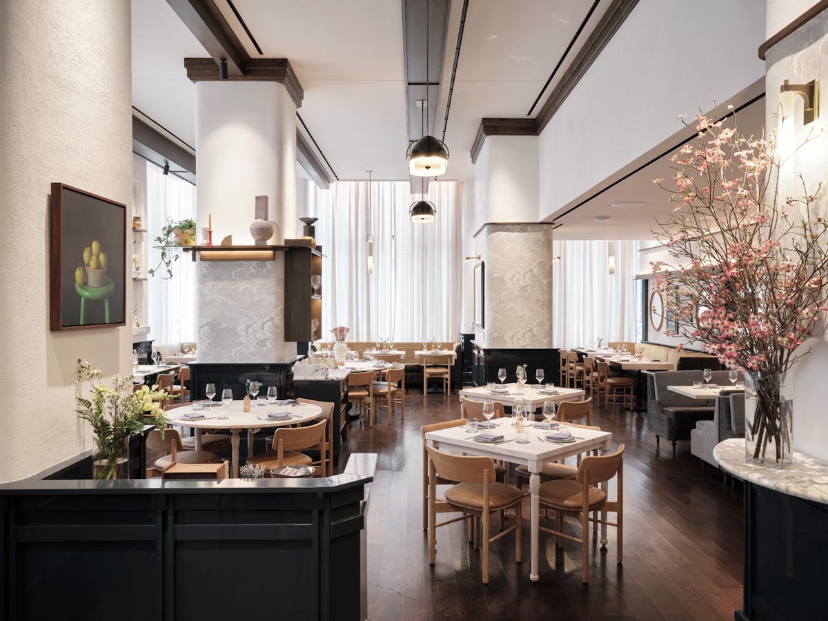 a room filled with furniture and vase of flowers on a kitchen counter, dining room, lunch, dinner, midtown, Hudson yards, nyc, private dining, restaurant