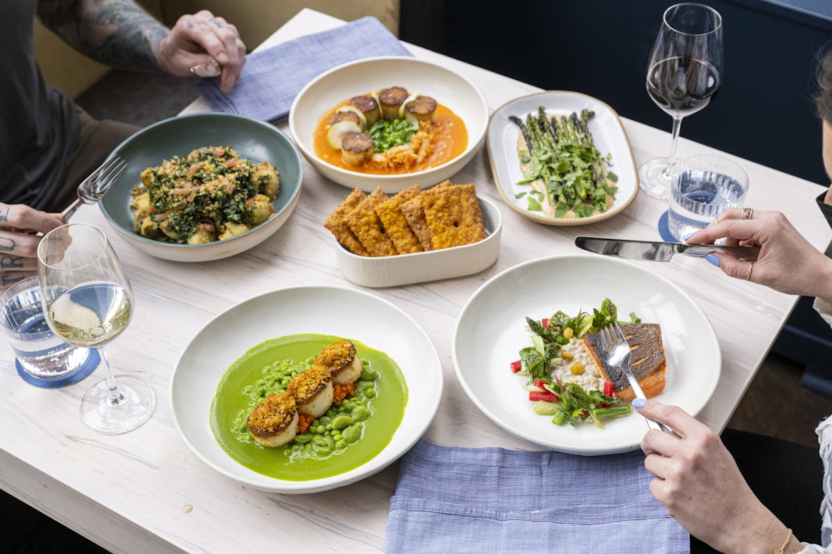 a person holding a plate of food on a table, lunch, dinner, midtown, Hudson yards, nyc, private dining, restaurant