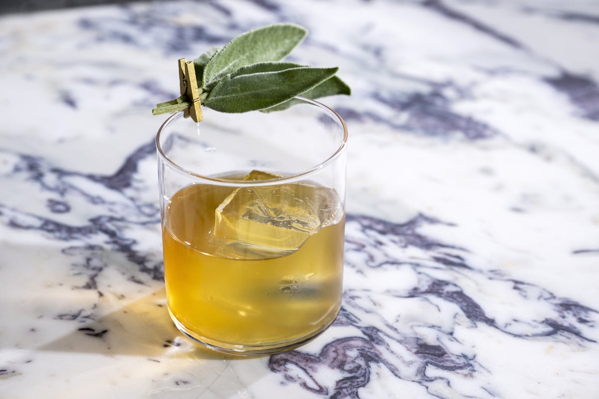 a glass of orange juice next to a cup of water, cocktail, lunch, dinner, midtown, Hudson yards, nyc, private dining, restaurant