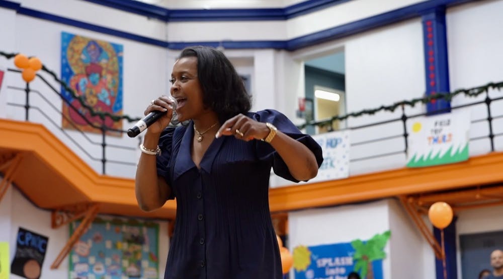 a woman standing in front of a building talking on a cell phone