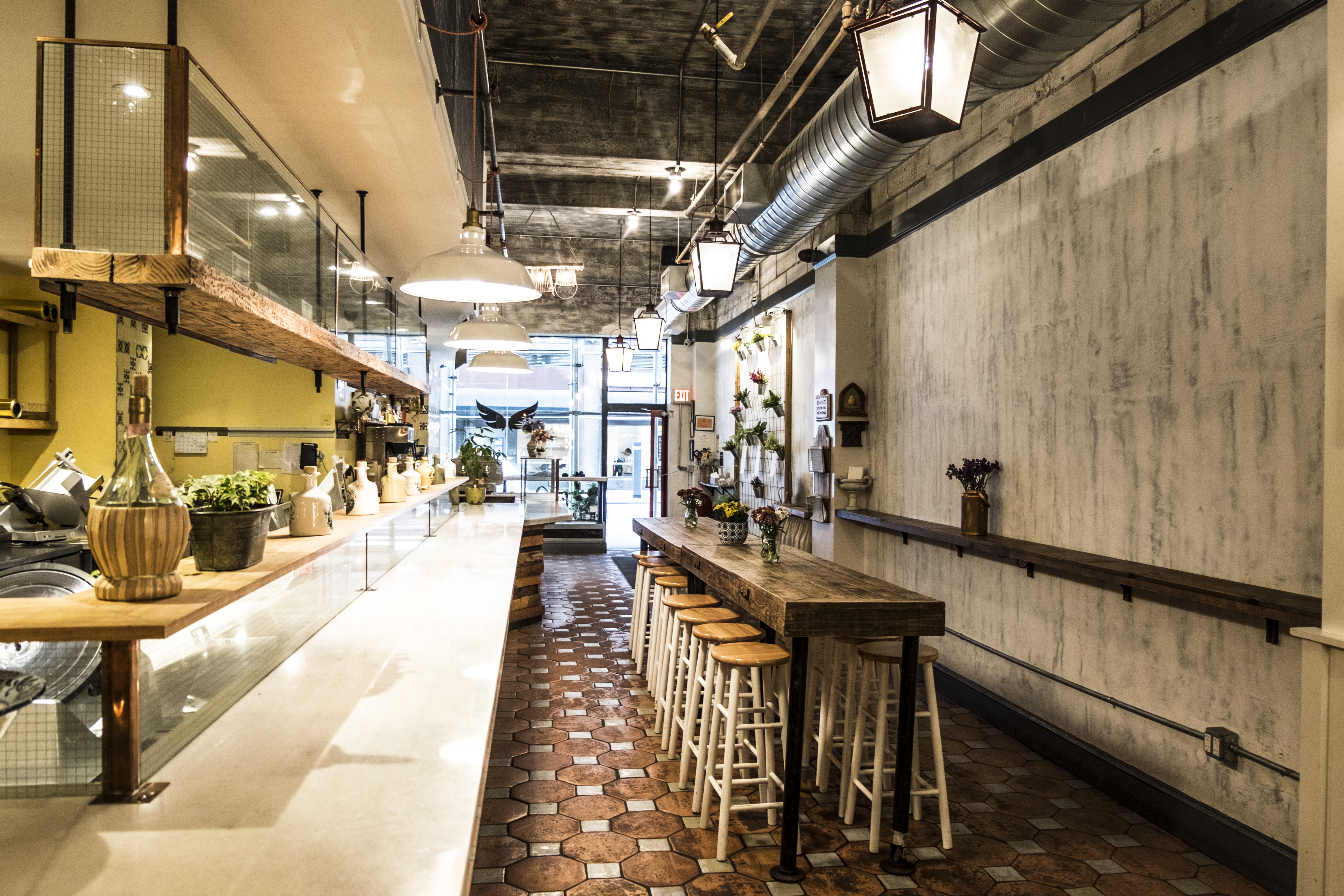 a restaurant with a long table and stools