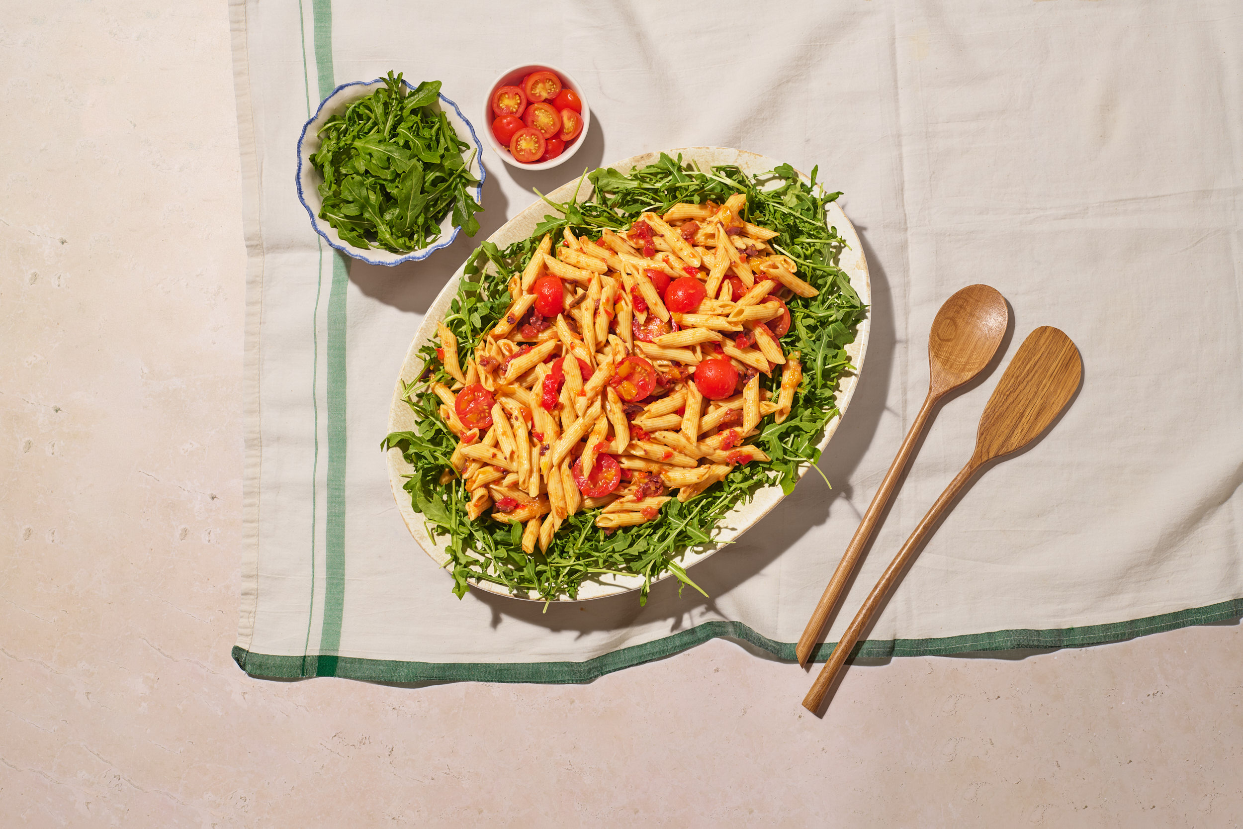 a plate of pasta salad and salad on a table