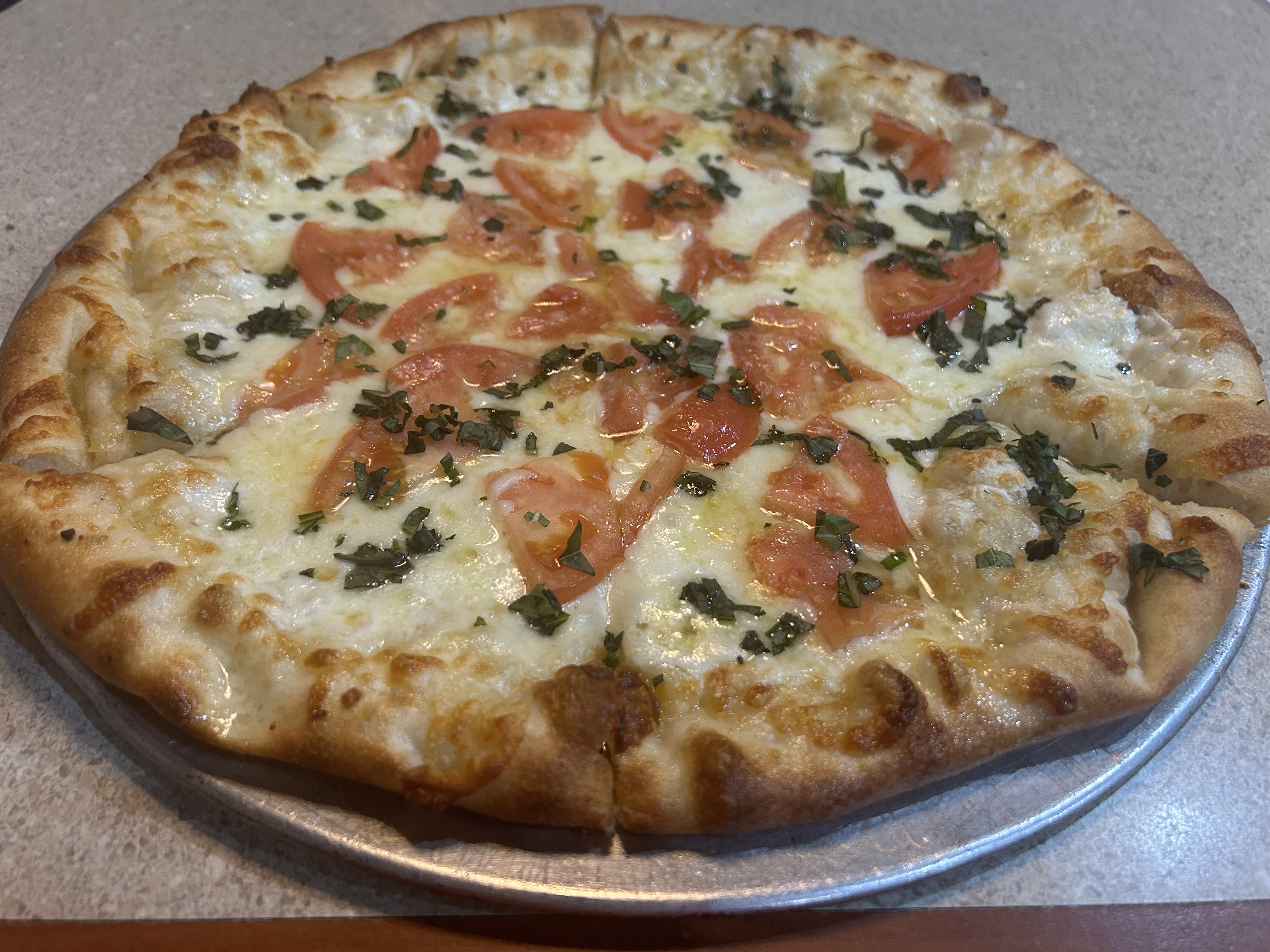 a pizza sitting on top of a metal pan