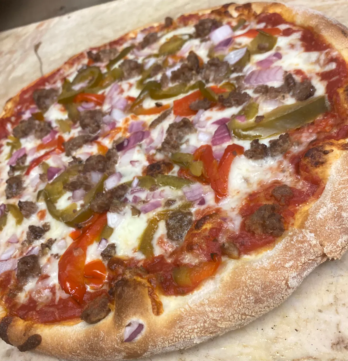 a pizza sitting on top of a cutting board