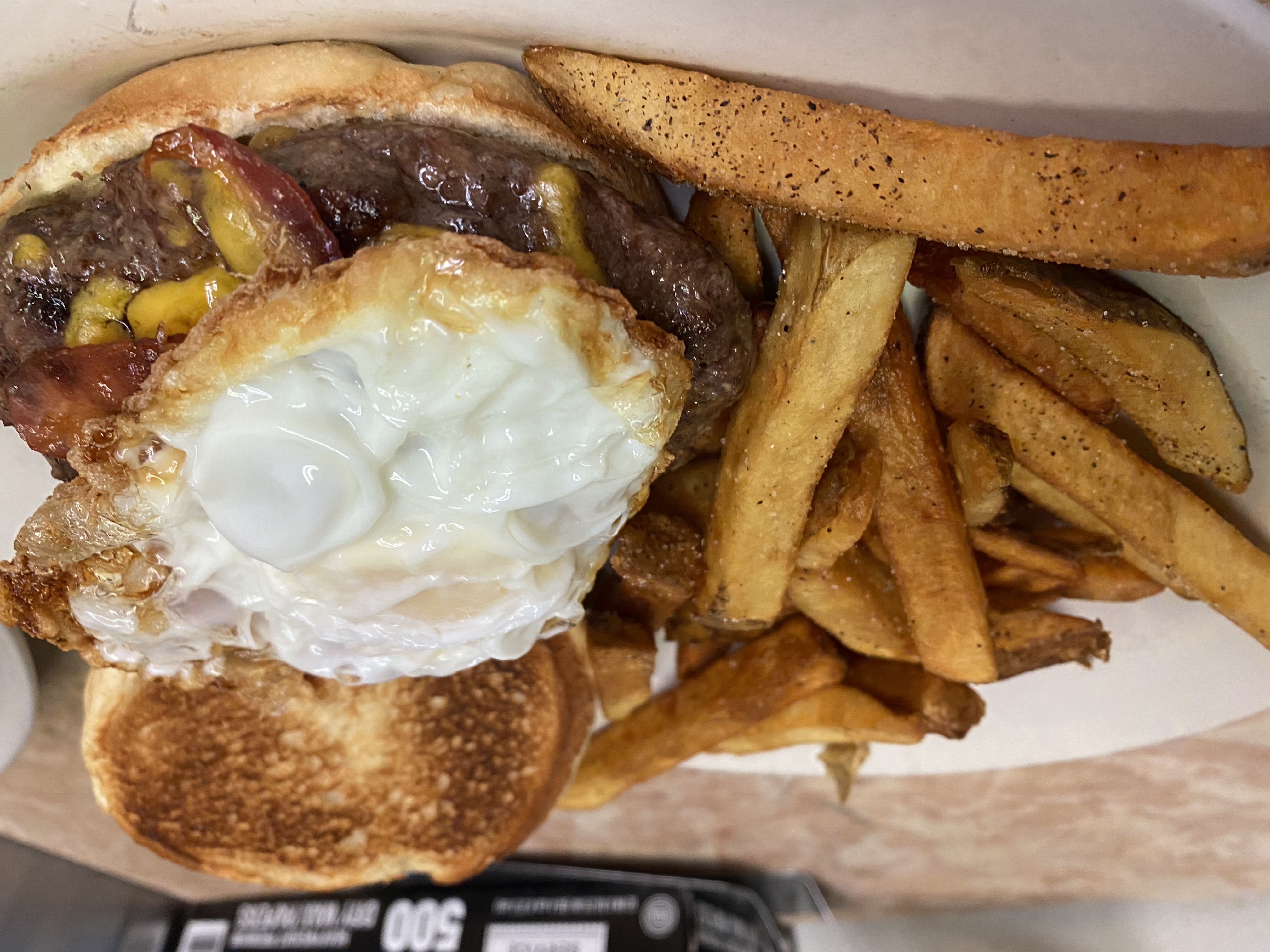 a close up of a sandwich and fries on a plate
