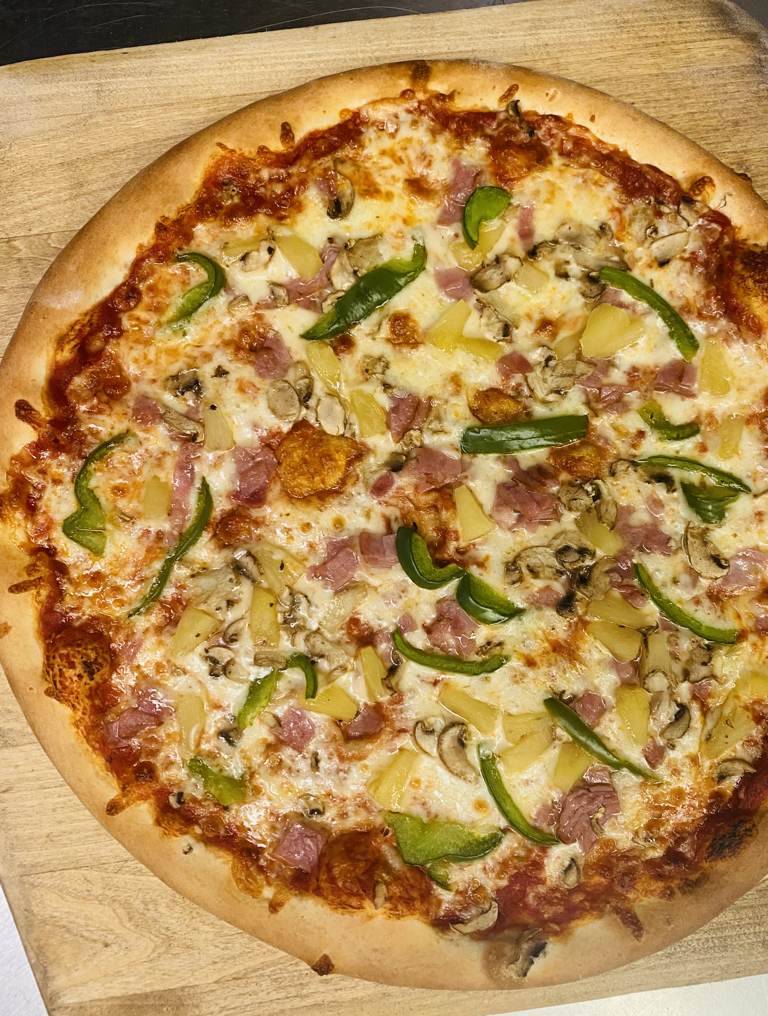 a pizza sitting on top of a cutting board