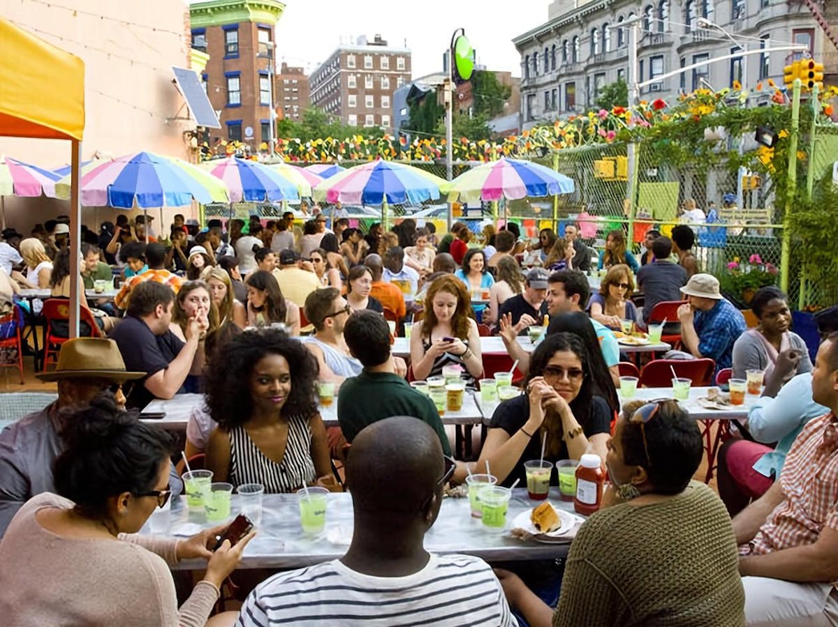 a group of people sitting at a table in front of a crowd