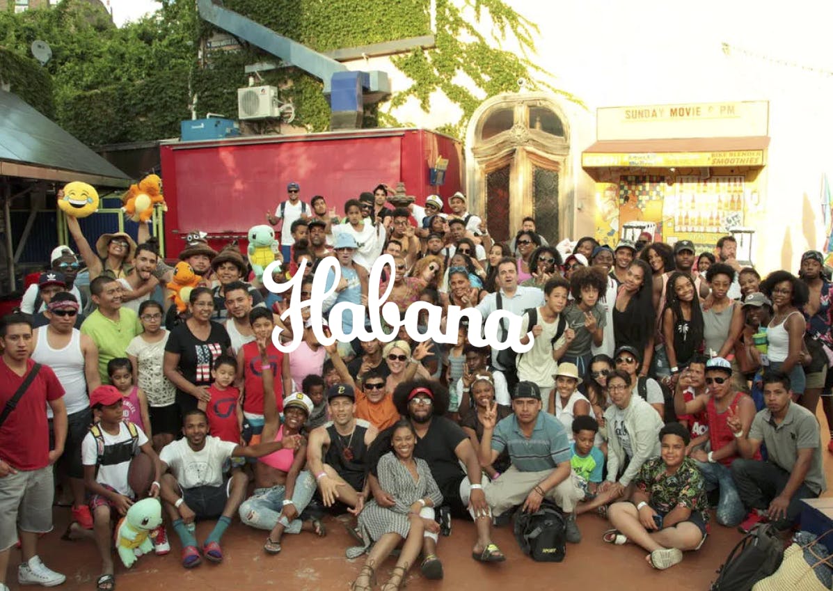 a group of people standing in front of a crowd posing for the camera