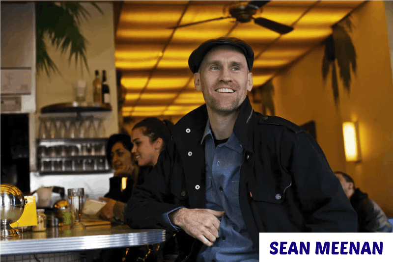 Sean Meenan standing in front of a table