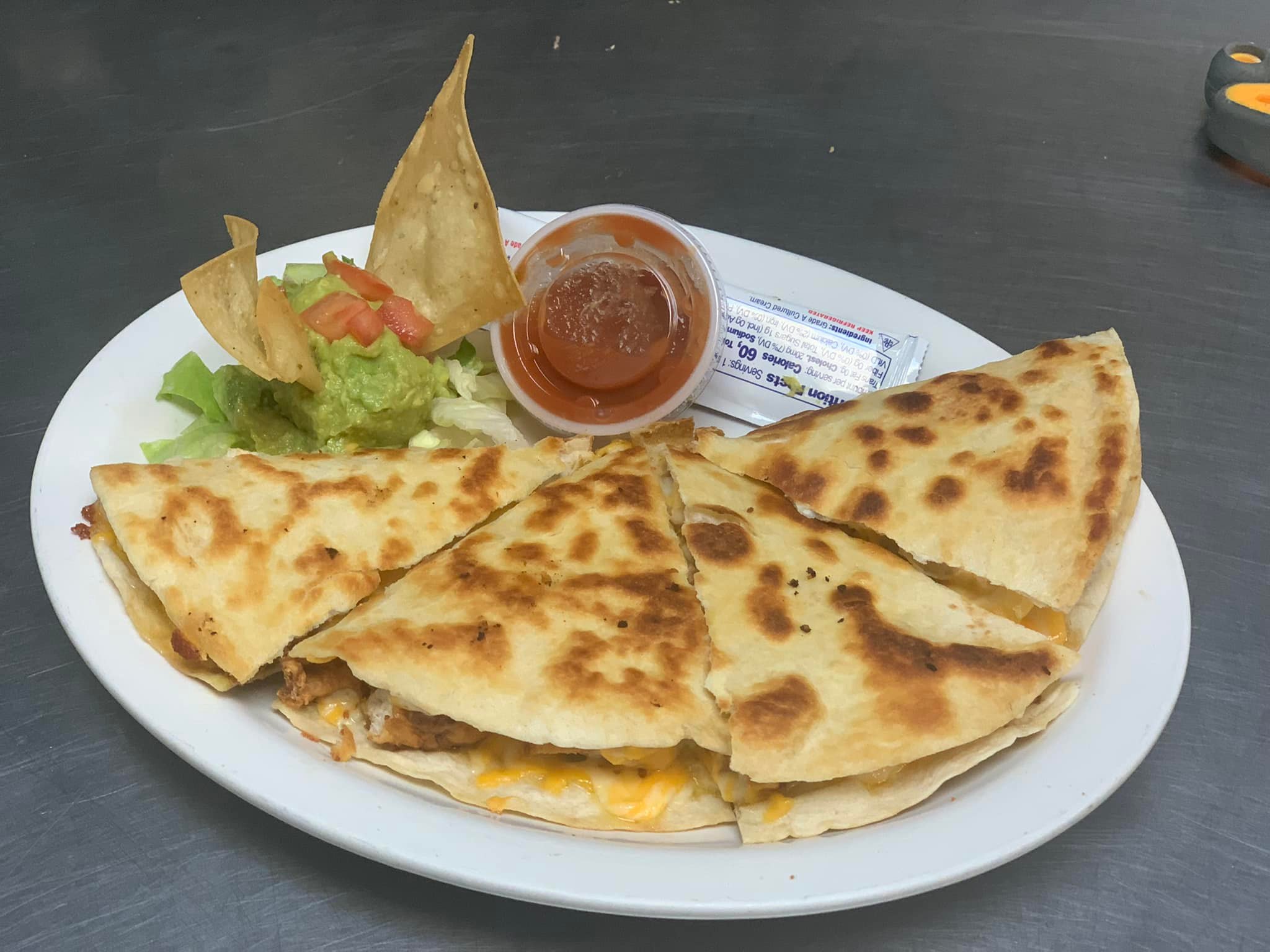 Chicken Quesdilla with fried chicken, cheese, and green chili.  Comes with a side of guacamole, sour cream, and hot sauce.
