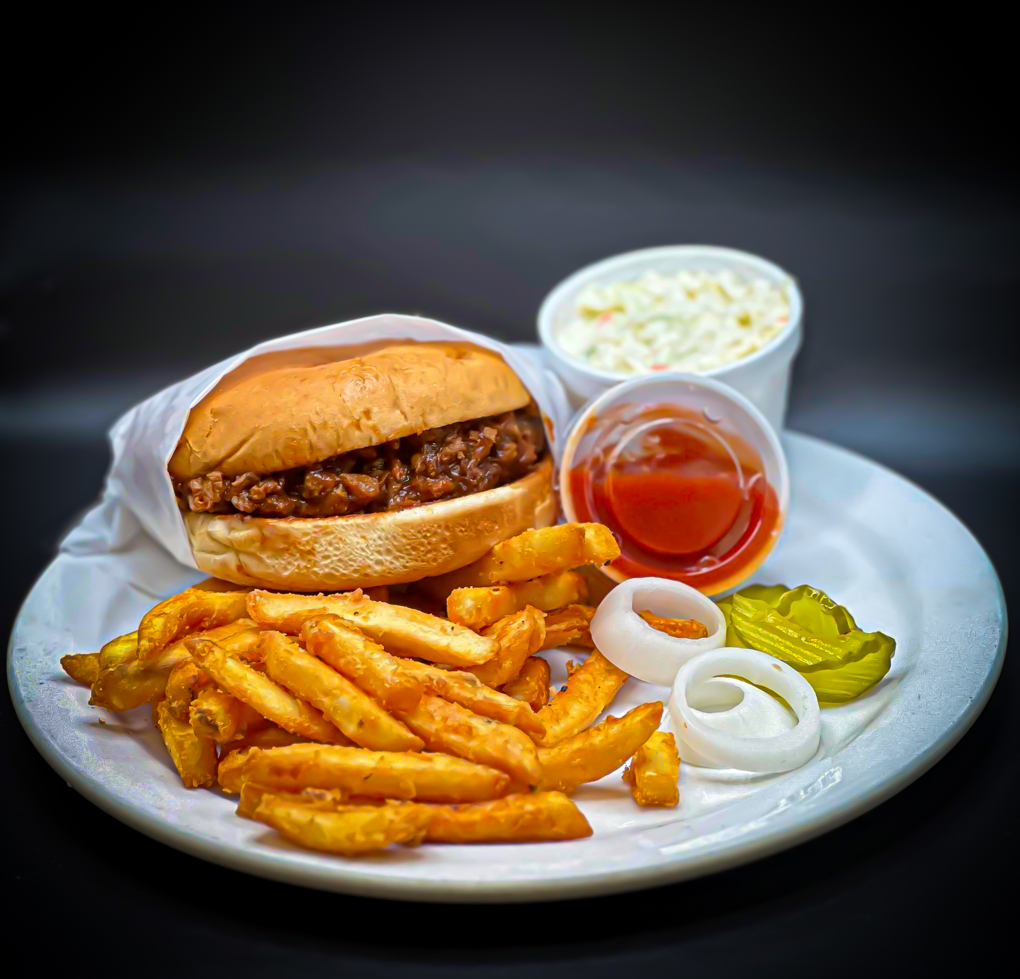 a plate of food with a sandwich and fries on a table