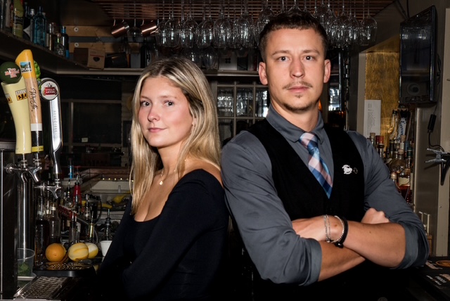 a man and a woman standing in a kitchen