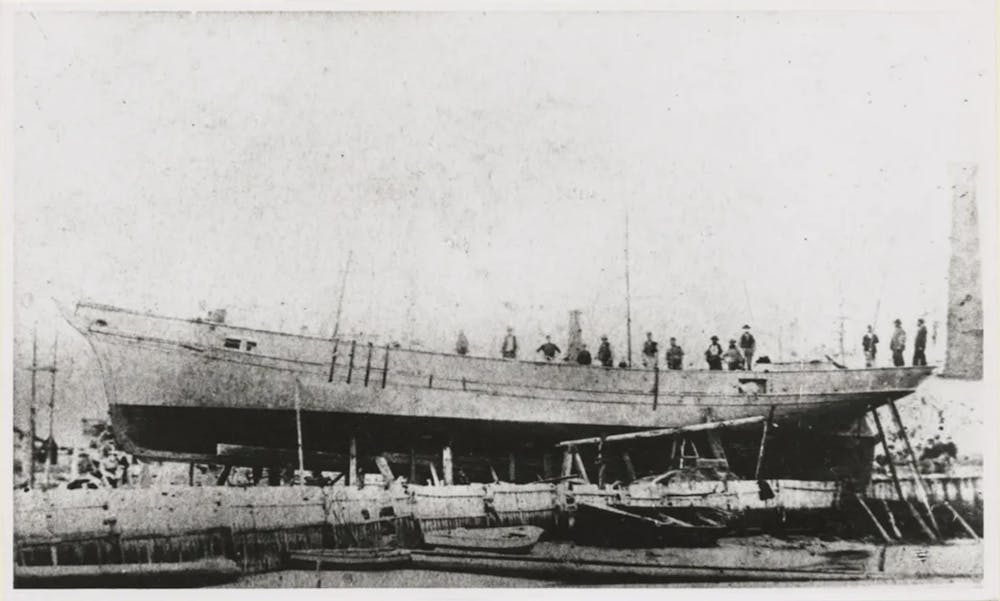 a vintage photo of a boat next to a body of water