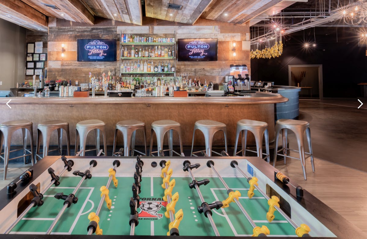 a group of people sitting at a table in front of a building