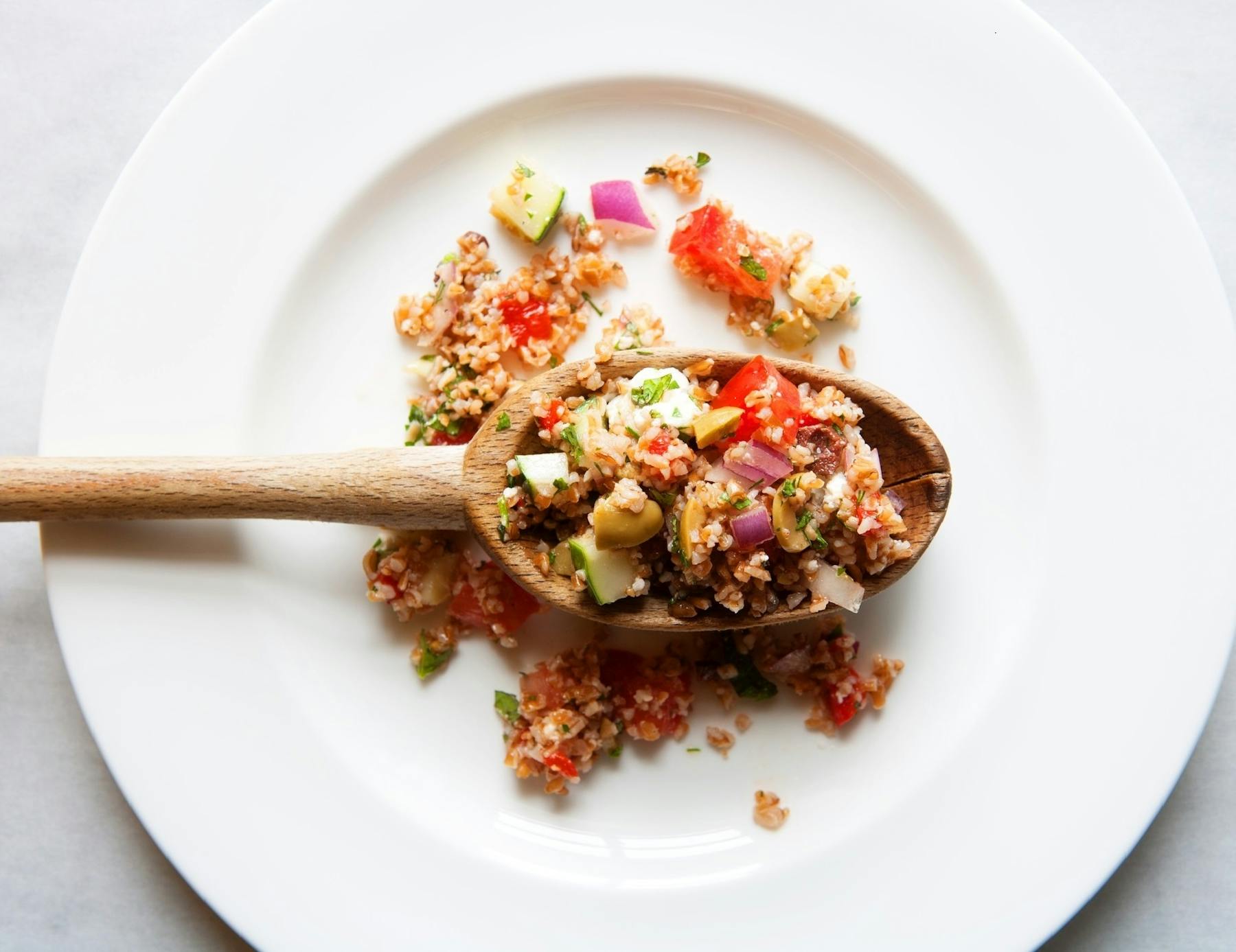 a white plate topped with meat and vegetables