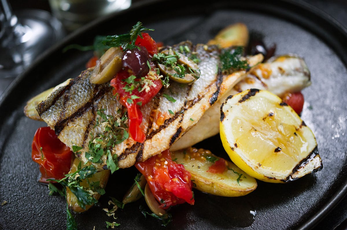 a plate topped with grilled chicken and vegetable