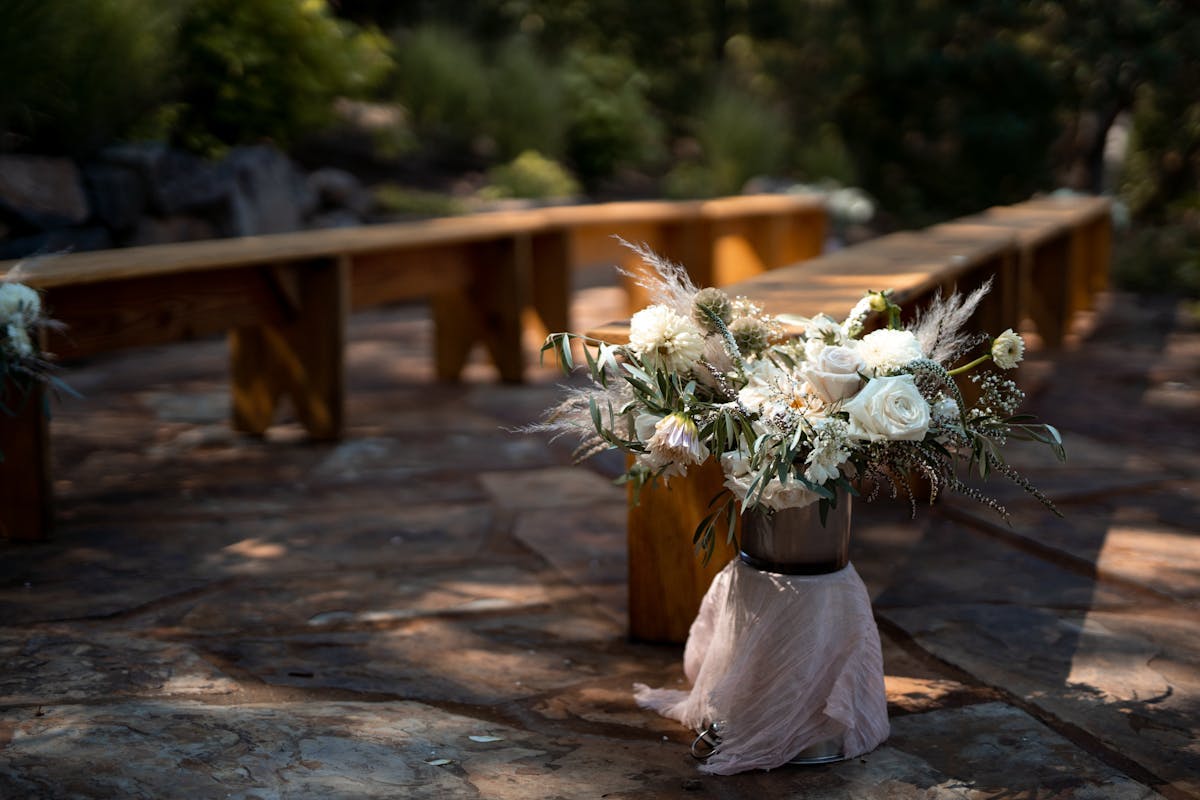 a vase of flowers sitting on top of a wooden table