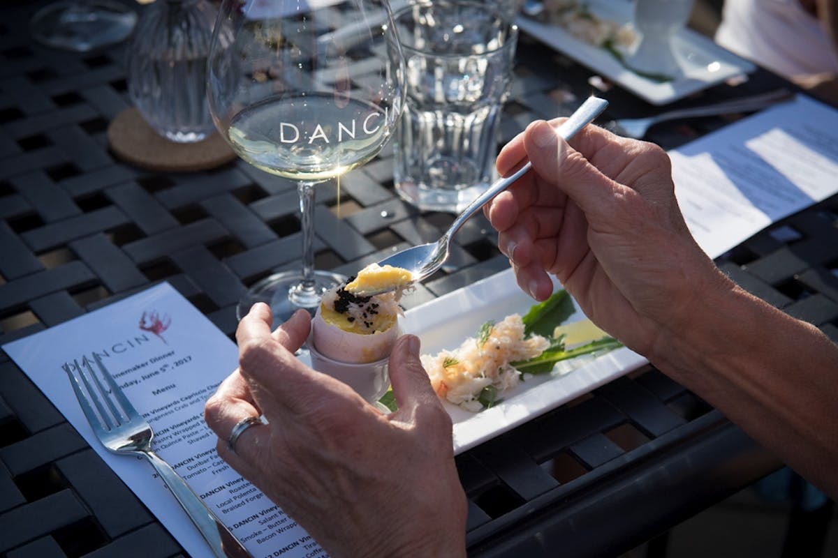 a person holding a wine glass on a table