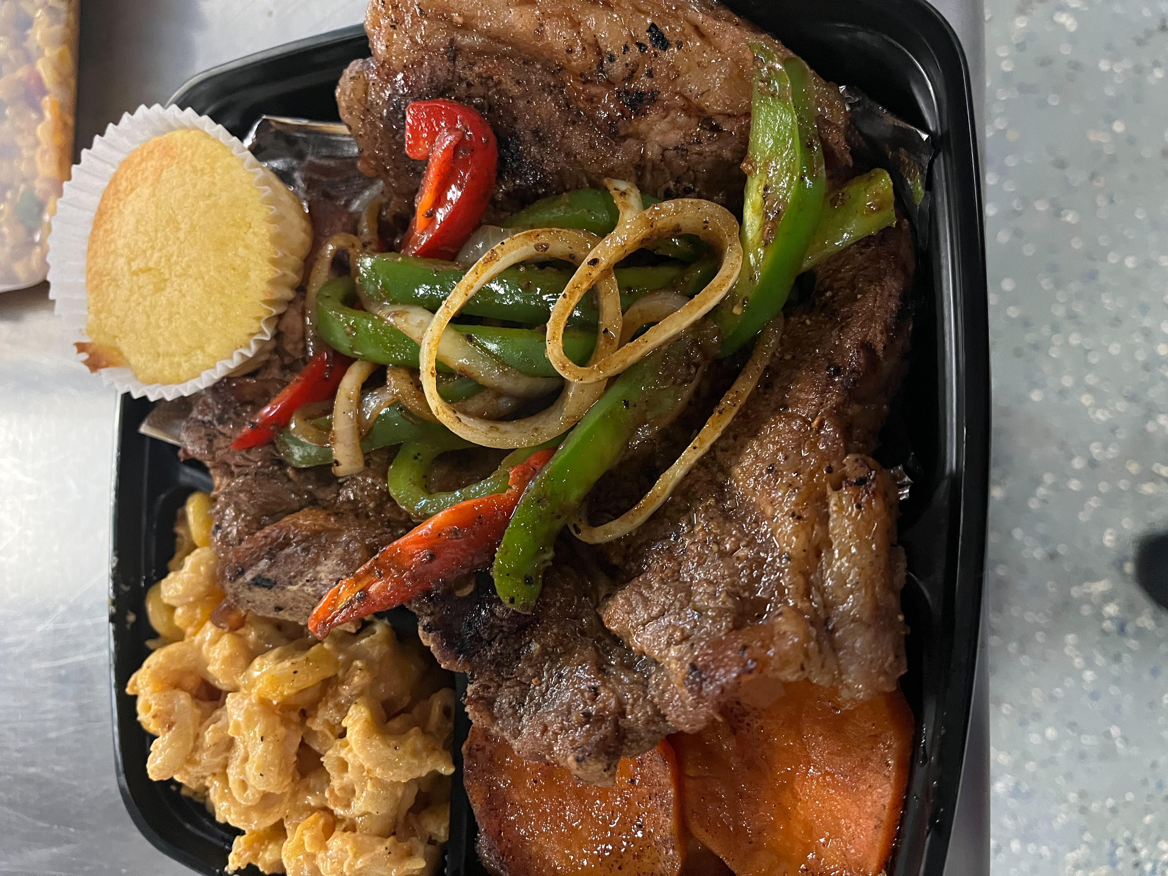 a plate of food with rice meat and vegetables