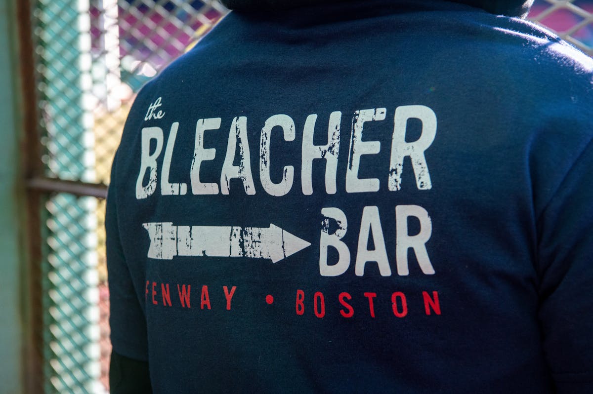 a person wearing a blue Bleacher Bar Sweatshirt