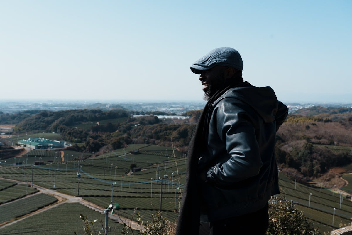 a man standing in front of a mountain