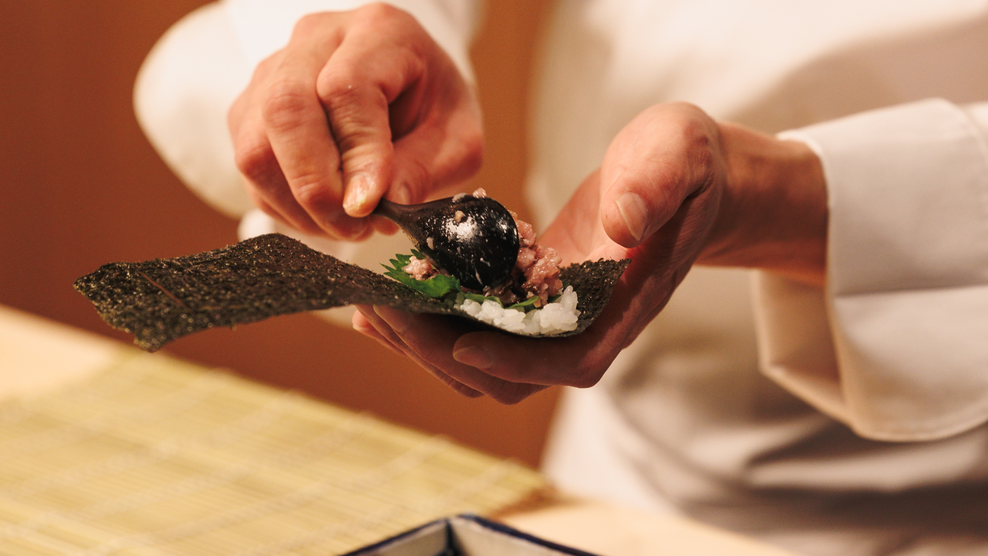 a person preparing food on a plate