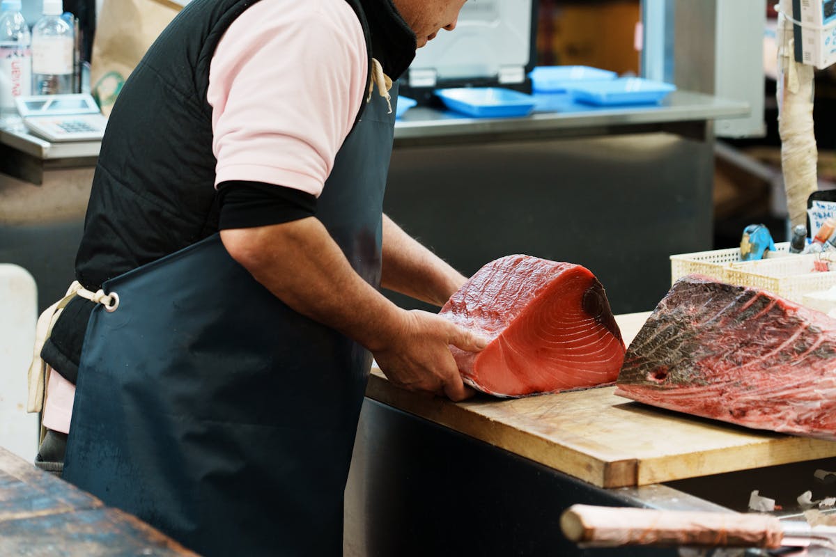 a man cutting food on a table