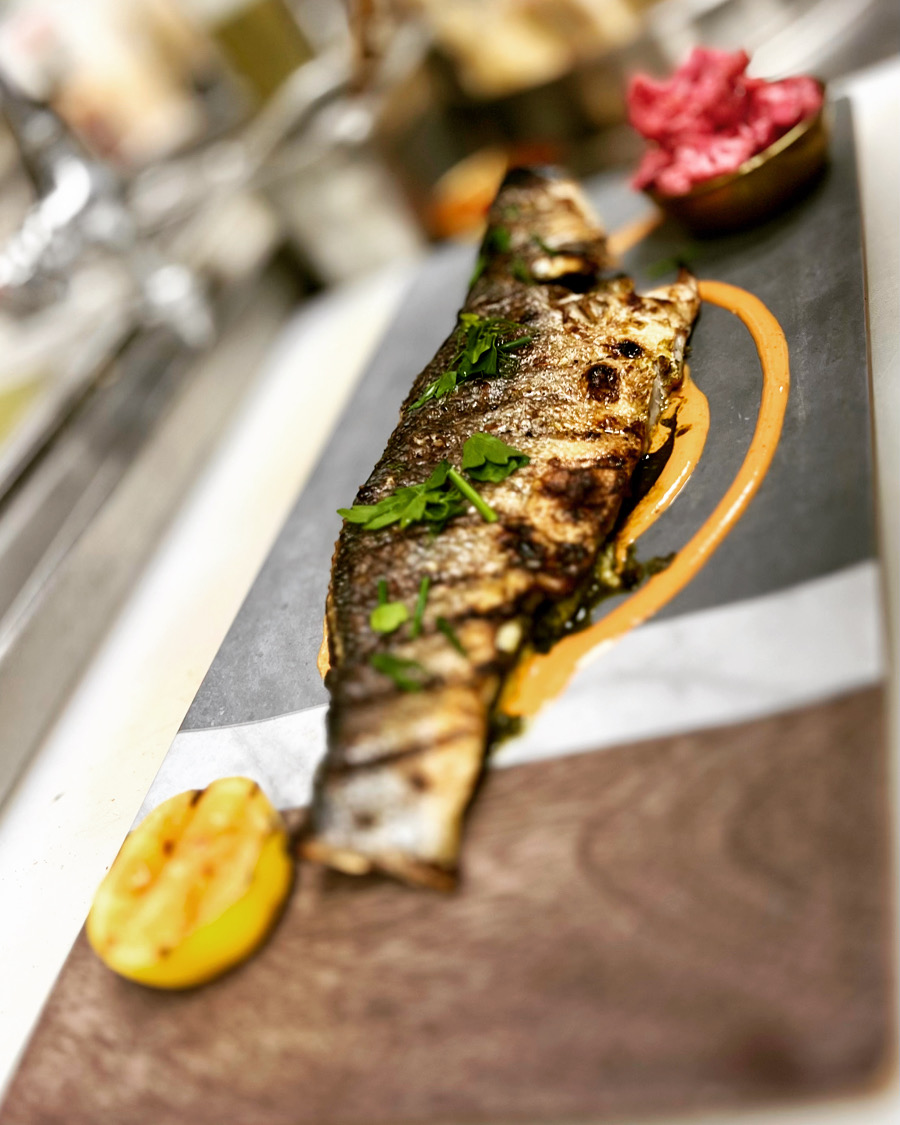 a slice of pizza sitting on top of a wooden cutting board