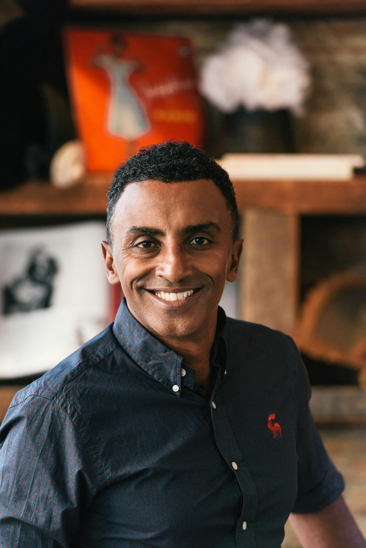 Marcus Samuelsson wearing glasses and smiling at the camera