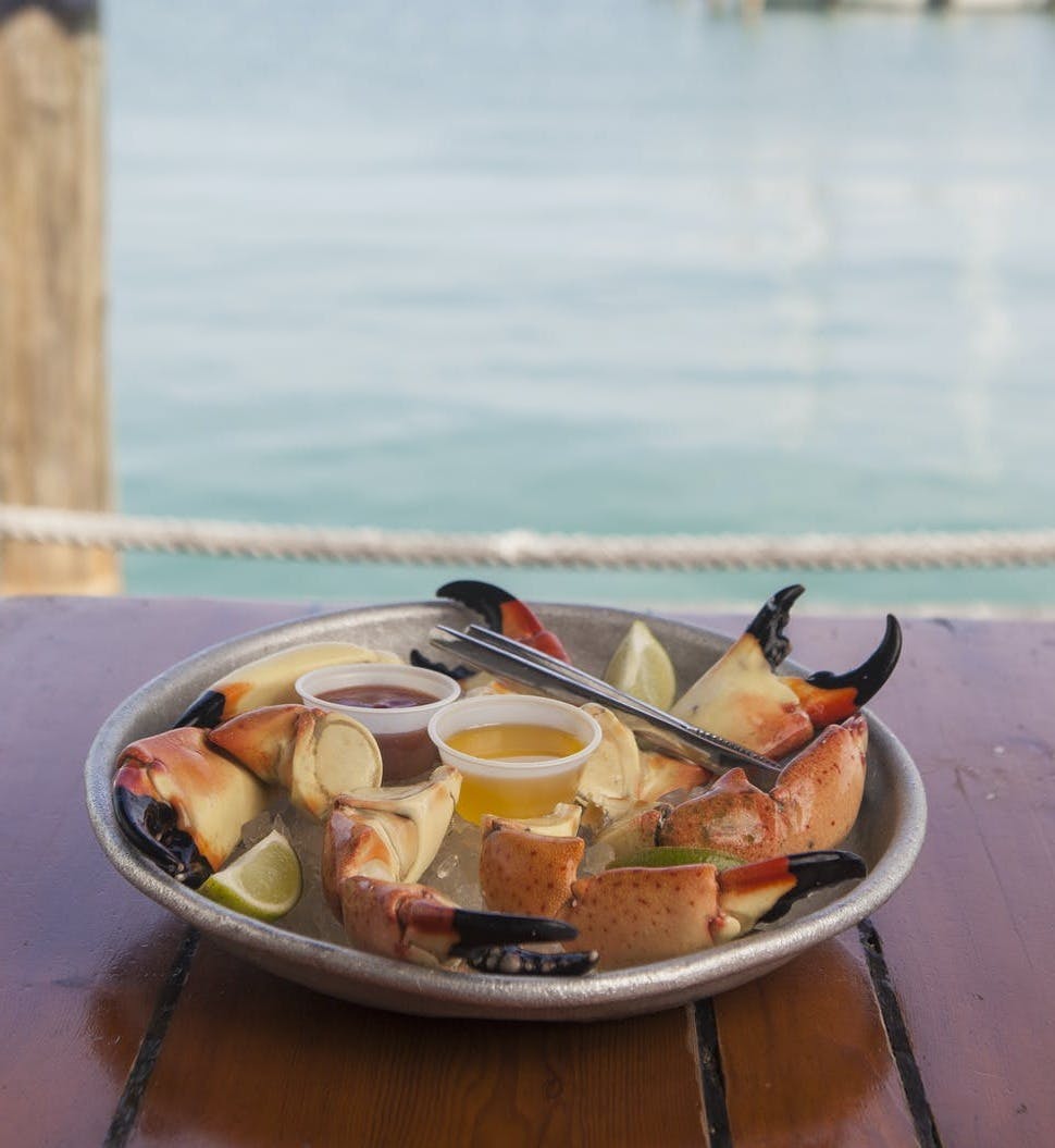 a plate of fresh seafood on a wooden table