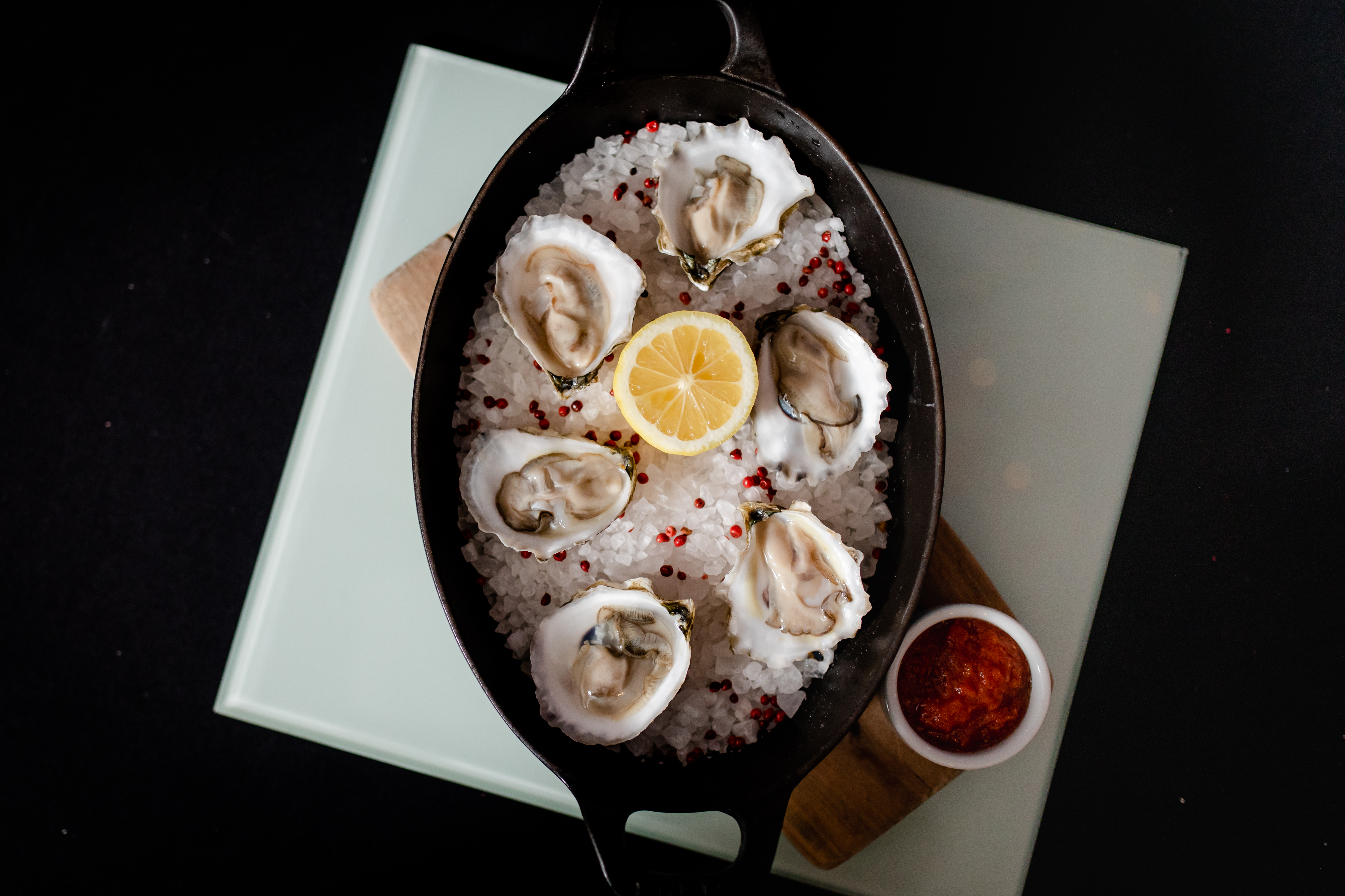 a bowl of oysters and lemon