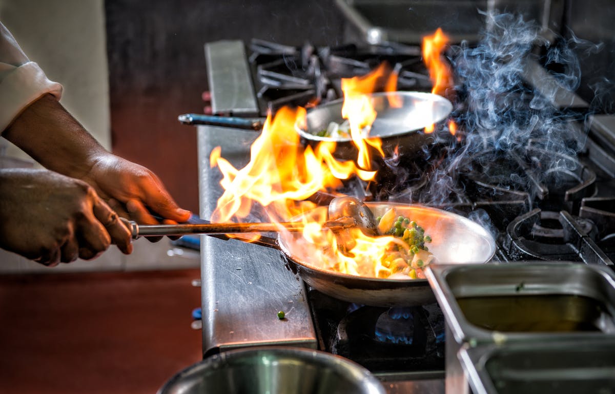 a person cooking food on a grill