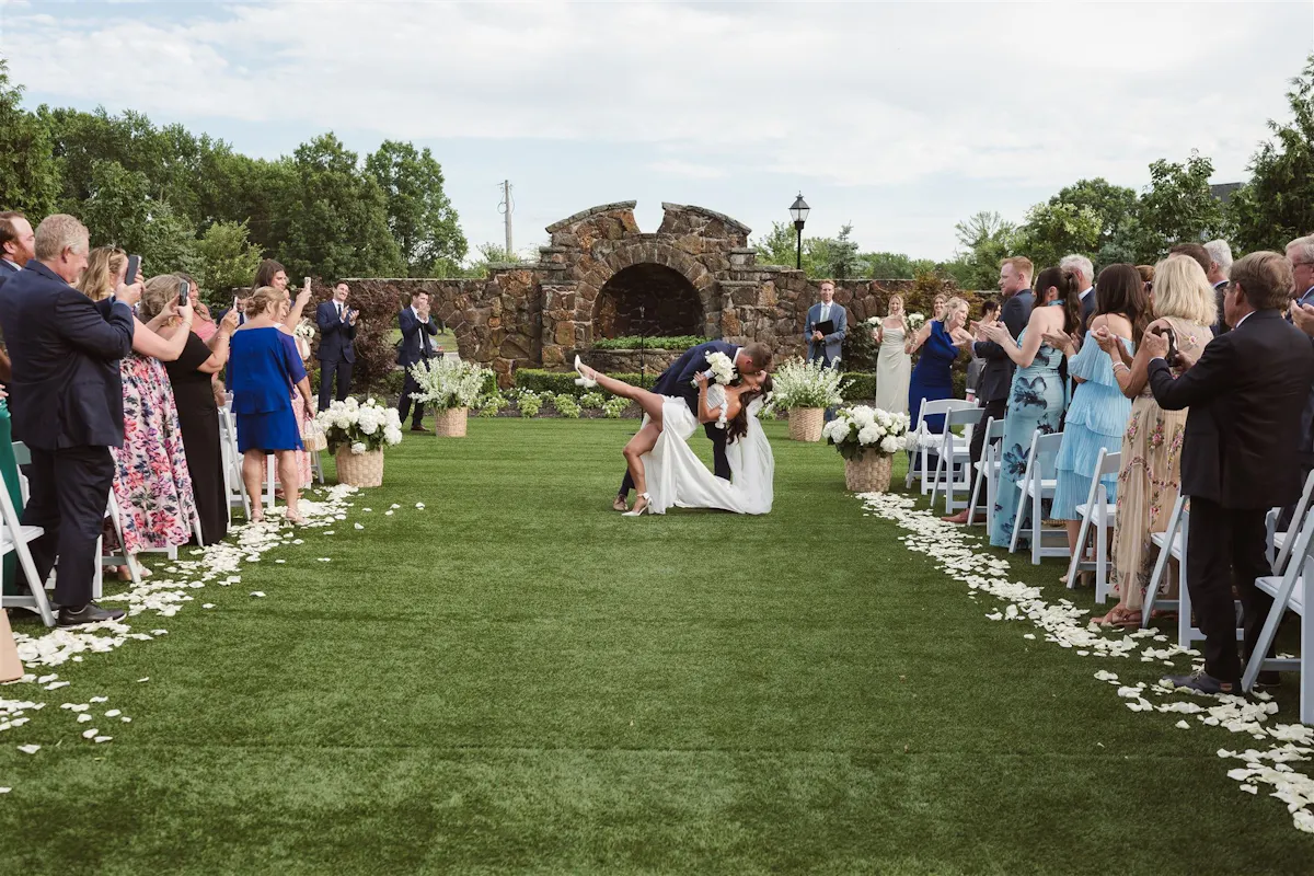 a man and woman kissing in a garden