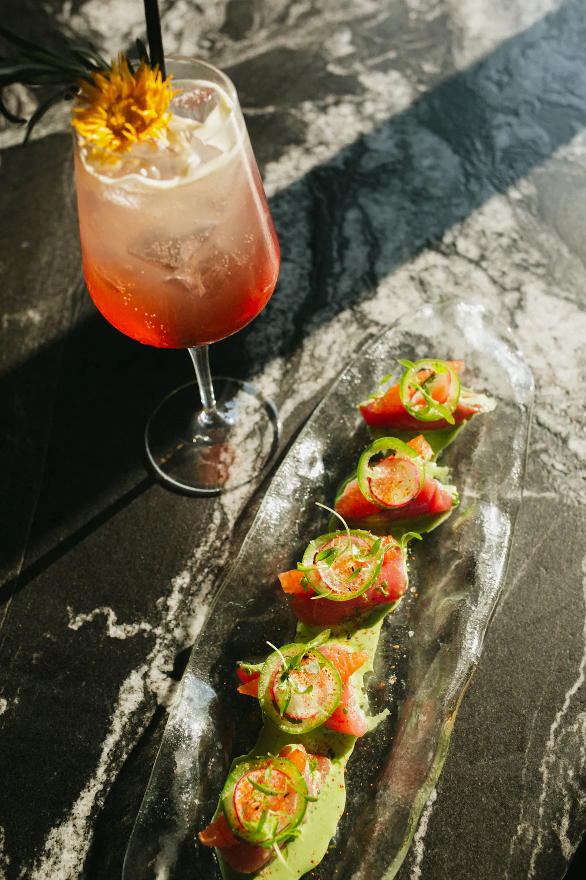 a glass of liquid next to food on a table