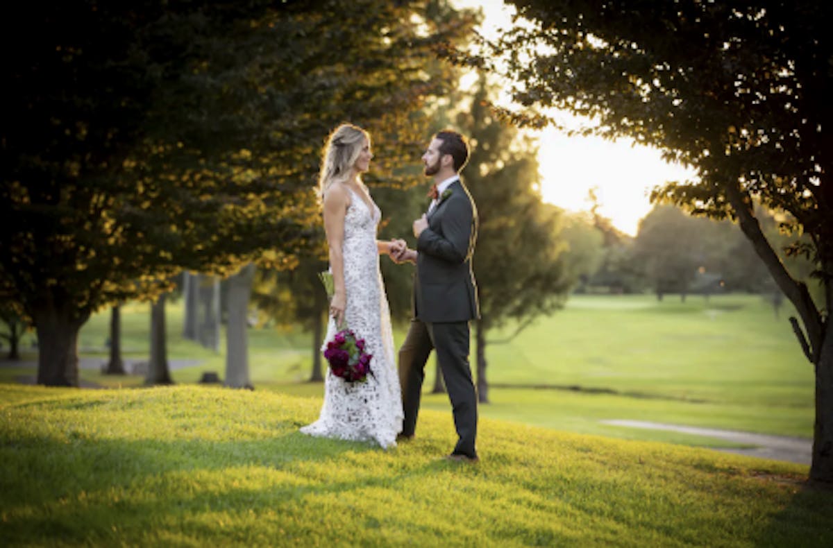 a person standing on top of a grass covered field