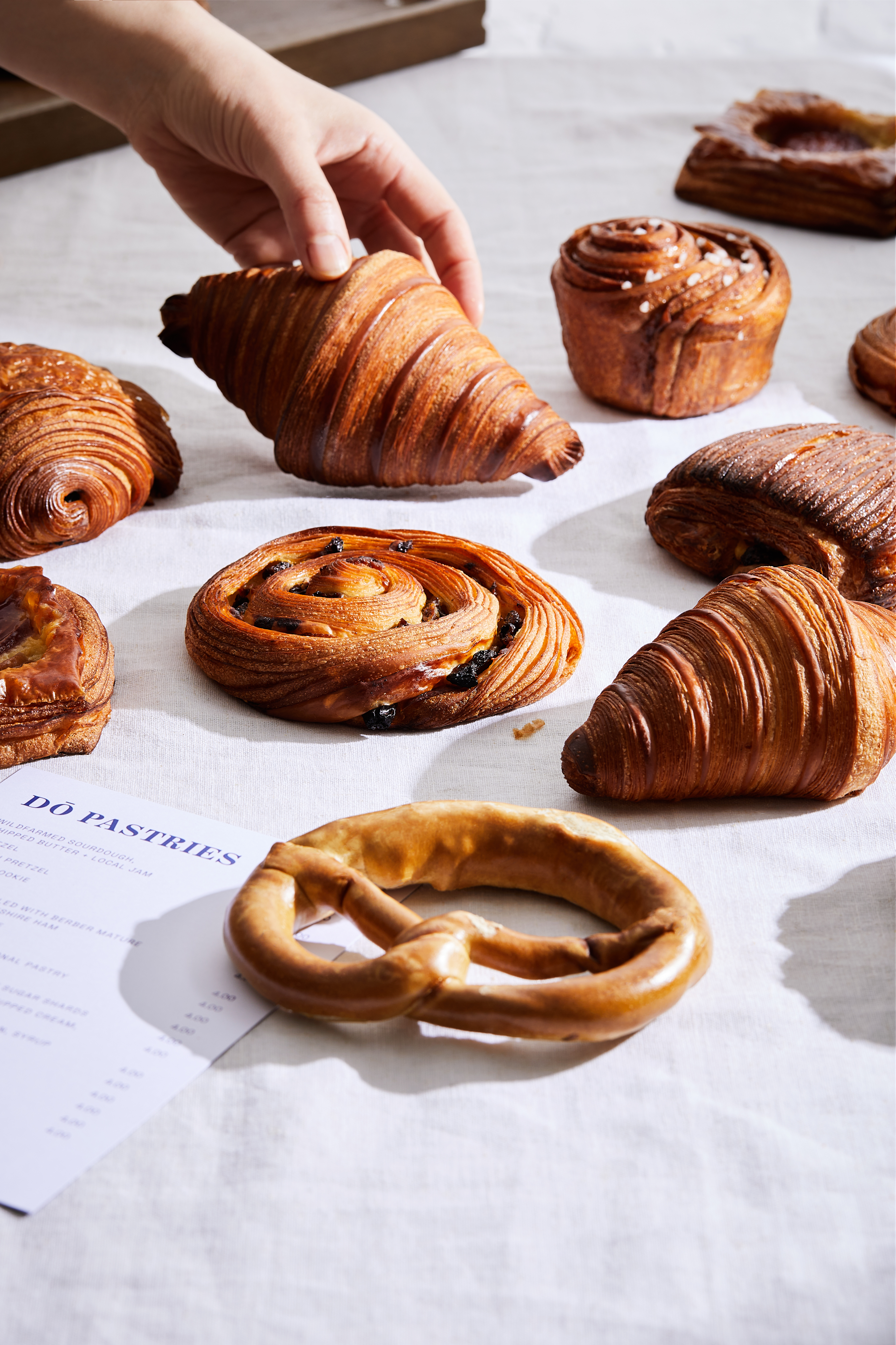 An individual sets a delicious pastry on a table, highlighting the artistry of their baking skills
