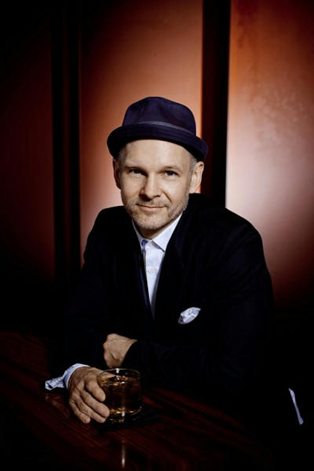 a man wearing a hat sitting on a table