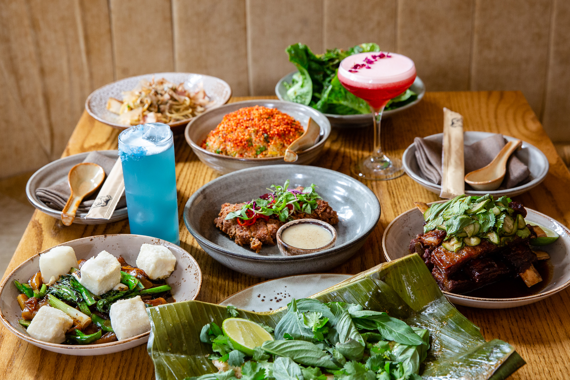 a bunch of food sitting on top of a wooden table
