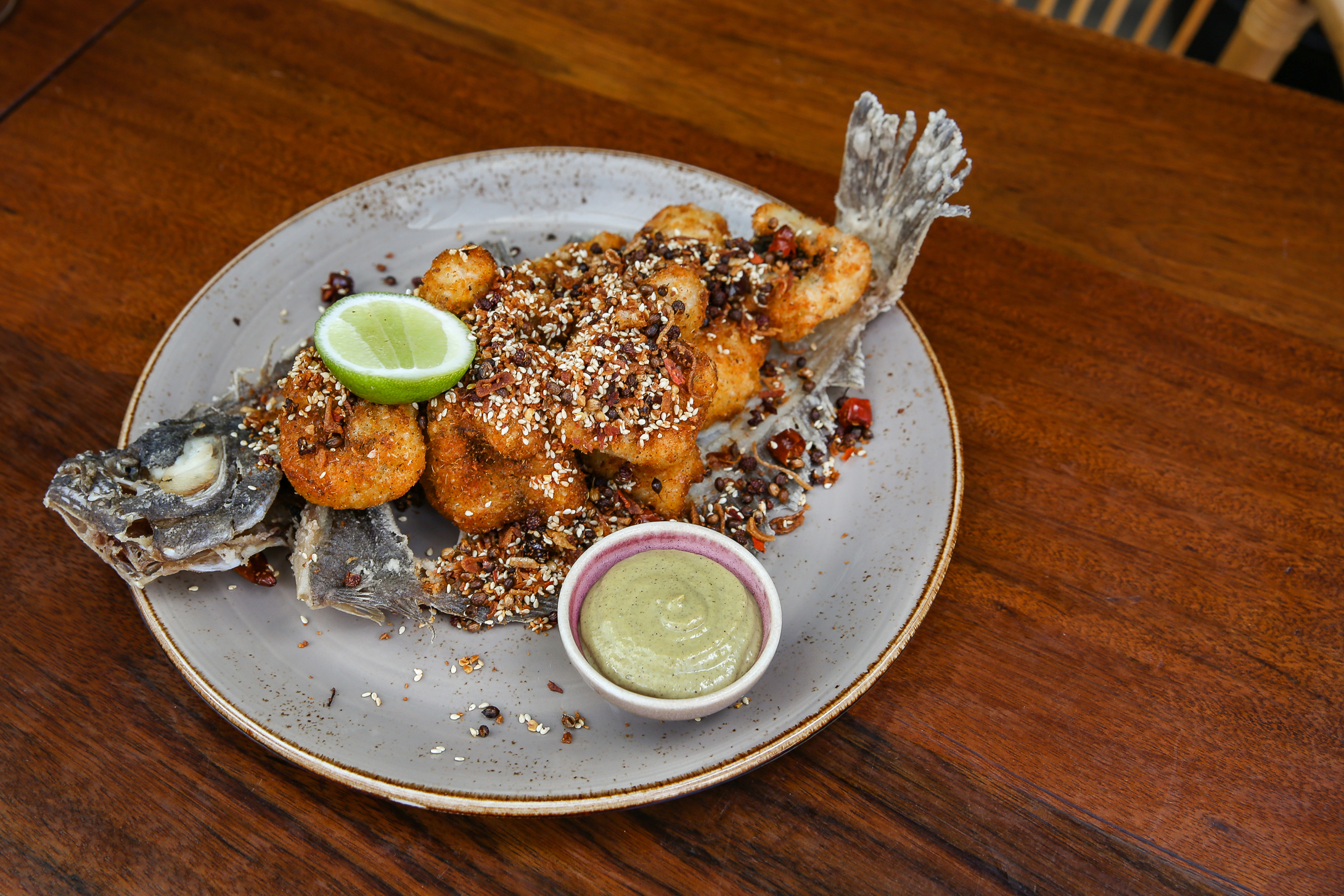 a plate of food sitting on top of a wooden table