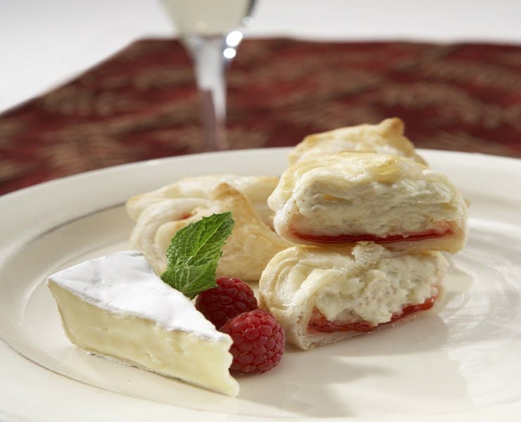 a white plate topped with a piece of cake on a table