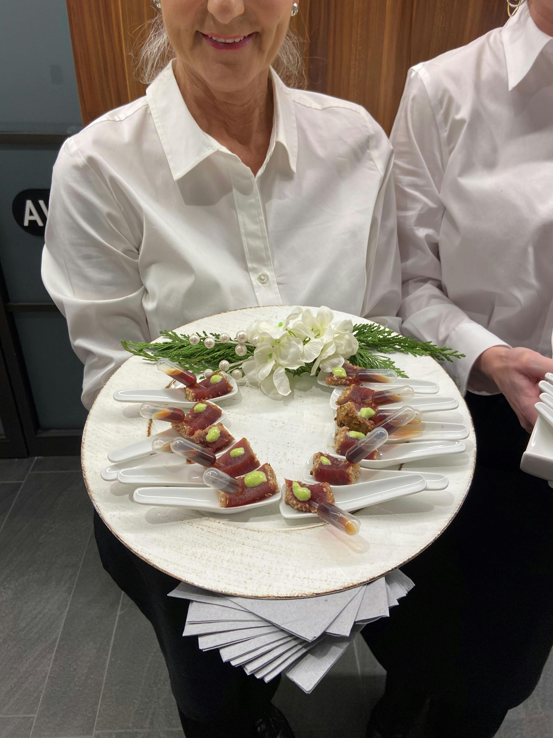 a woman sitting at a table with a plate of food